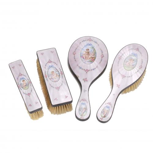 Silver and enamel. Comprises hand mirror, large brush and two small brushes. 26 cm.,17 cm., 23 cm., 15 cm. 