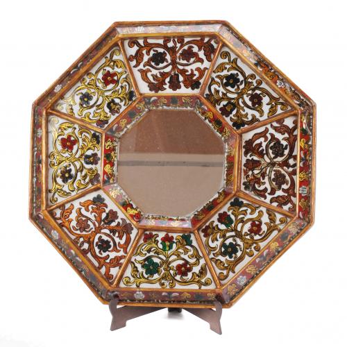 Octogonal wood mirror, hand painted floral motives on glass. Some losses.43 cm. diam.