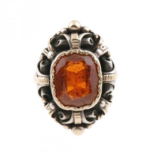 Silver and gold with central garnet 1,3x1,1x cm.Ring size 16 mm.11,7 gr.