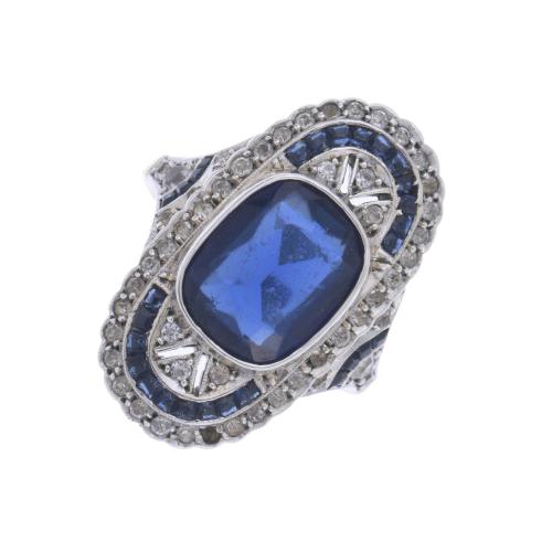 PLATINUM SHUTTLE RING WITH BLUE CORUNDUM AND SAPPHIRES.