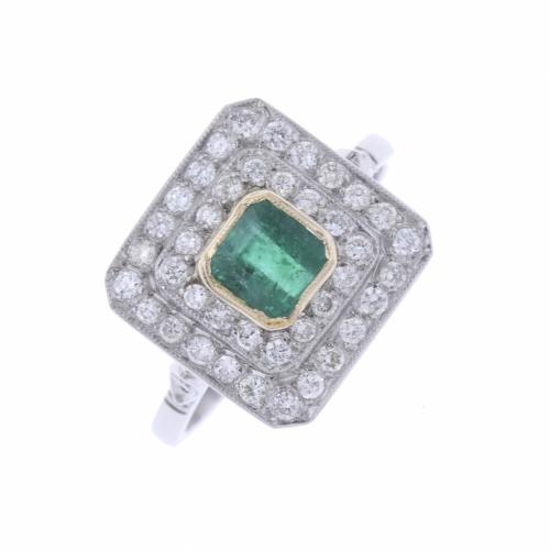 PLATINUM RING WITH EMERALD AND DIAMONDS.