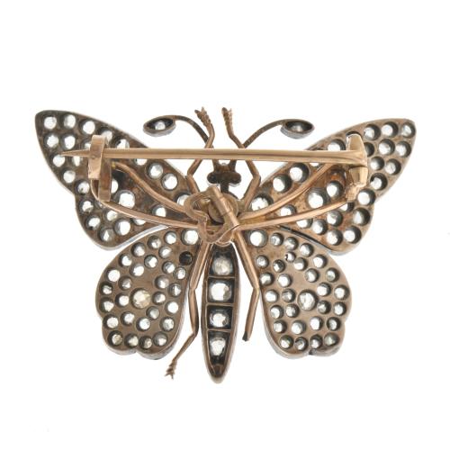 Butterfly-shaped brooch with diamonds.