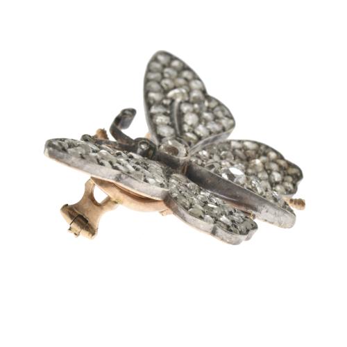 Butterfly-shaped brooch with diamonds.