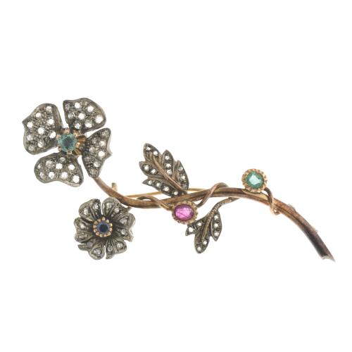 Floral brooch with emeralds, ruby and sapphire.