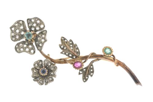 Floral brooch with emeralds, ruby and sapphire.