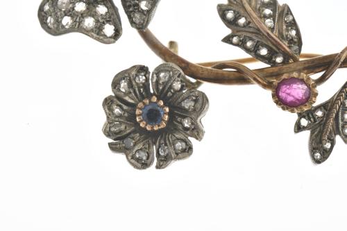 Floral brooch with emeralds, ruby and sapphire.