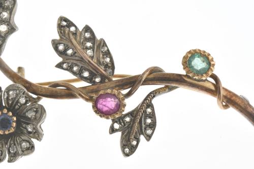 Floral brooch with emeralds, ruby and sapphire.