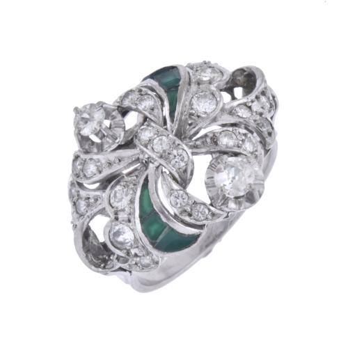 Loop-shaped ring with emerald simile and diamonds.