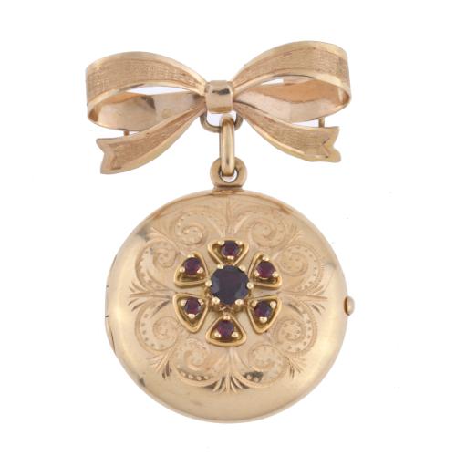 Bow-shaped brooch with locket pendant, with rubies.